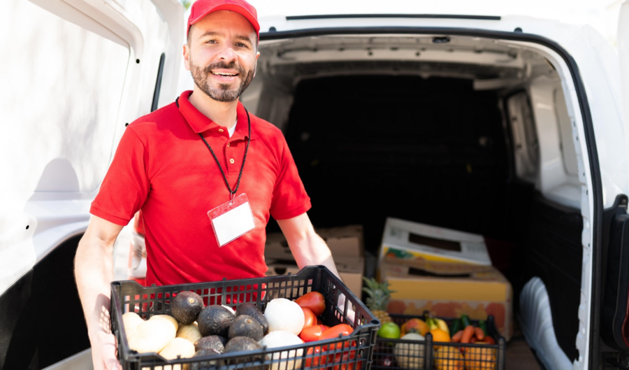 delivery man holding a box of fresh produce